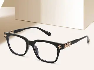 Black rectangular glasses frames on a white surface